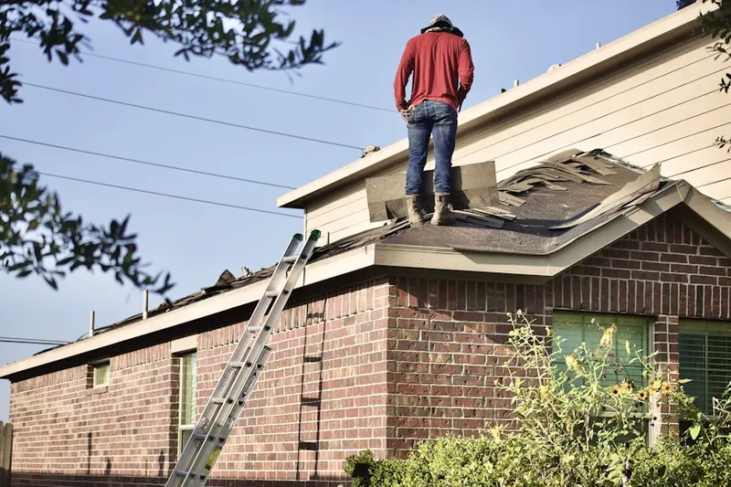Professional roofer working on a residential roof in Herlong